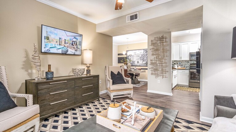 Spacious living room with crown molding and ceiling fan