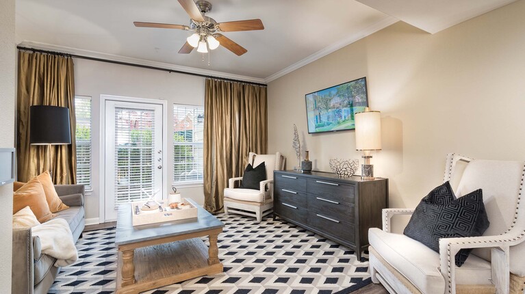 Spacious living room with crown molding and ceiling fan