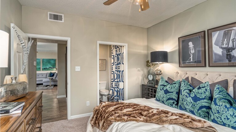 Bedroom with ceiling fan and attached bathroom