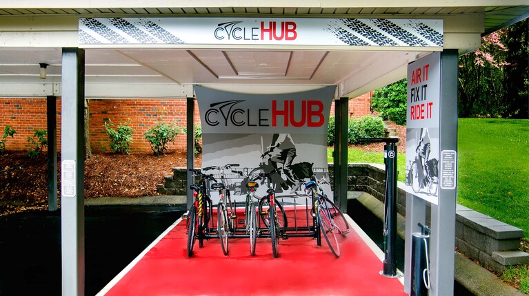 Cycle hub with covered storage and repair station
